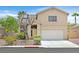Charming two-story home with well-maintained landscaping and a two-car garage at 681 Peach Coral St, Las Vegas, NV 89183