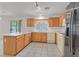 Well-lit kitchen featuring ample counter space and stainless steel appliances at 681 Peach Coral St, Las Vegas, NV 89183