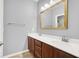 Bathroom features dual sinks with storage below and a large mirror at 7806 Sundial Peak St, Las Vegas, NV 89166