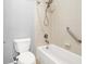 Bright bathroom featuring a shower-over-tub combo with tiled walls and a supportive grab bar for accessibility at 7806 Sundial Peak St, Las Vegas, NV 89166