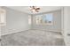 Spacious bedroom with plush carpeting and abundant natural light from the three large windows at 7806 Sundial Peak St, Las Vegas, NV 89166