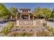 A welcoming clubhouse with stone accents, manicured landscaping, and vibrant flowerbeds at 7806 Sundial Peak St, Las Vegas, NV 89166