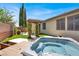 Backyard featuring a hot tub, pergola with climbing plants, and a well-maintained lawn at 7806 Sundial Peak St, Las Vegas, NV 89166