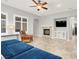 Inviting living room with a cozy fireplace, comfortable seating and large windows at 7806 Sundial Peak St, Las Vegas, NV 89166