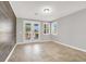 Bright living area with stylish wood accent wall and natural light from the French doors at 7806 Sundial Peak St, Las Vegas, NV 89166