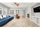Living room featuring cozy furniture, fireplace, and plenty of natural light at 7806 Sundial Peak St, Las Vegas, NV 89166