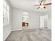 Open Primary bedroom with gray carpet, window shutters, ceiling fan, and en suite bath at 7806 Sundial Peak St, Las Vegas, NV 89166