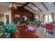 The recreation room has wood-paneled walls, beamed ceilings, and views of the well-manicured landscaping at 7806 Sundial Peak St, Las Vegas, NV 89166