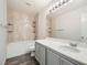 Bathroom with updated vanity, modern lighting and shower-tub combo at 7829 Lovely Pine Pl, Las Vegas, NV 89143