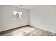 Bedroom features a window, wood-look floors, and white walls at 7829 Lovely Pine Pl, Las Vegas, NV 89143