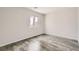 Bedroom with wood-look floors, a window and neutral paint at 7829 Lovely Pine Pl, Las Vegas, NV 89143