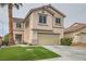 Two-story home with tile roof, two-car garage, and well-manicured artificial lawn at 7829 Lovely Pine Pl, Las Vegas, NV 89143