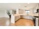Modern kitchen with stainless steel appliances, light wood cabinets, and breakfast bar at 7829 Lovely Pine Pl, Las Vegas, NV 89143