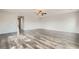 Open living room with hardwood floors, ceiling fan, and neutral walls at 7829 Lovely Pine Pl, Las Vegas, NV 89143