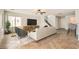 Bright living room with modern furnishings, neutral tones, and staircase at 7829 Lovely Pine Pl, Las Vegas, NV 89143