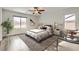 Bright main bedroom featuring a ceiling fan and windows at 7829 Lovely Pine Pl, Las Vegas, NV 89143