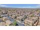 Expansive aerial view of a large neighborhood featuring uniform homes with tiled roofs under a clear blue sky at 7865 Solid Horn Ct, Las Vegas, NV 89149