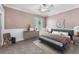 This bedroom features a large window, a ceiling fan, and a modern decor at 7865 Solid Horn Ct, Las Vegas, NV 89149