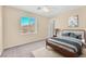 This bedroom features a large window for lots of light, a ceiling fan, and a plush carpet at 7865 Solid Horn Ct, Las Vegas, NV 89149