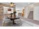 Dining area features a round table with seating for six, stone accent walls, and updated lighting at 7865 Solid Horn Ct, Las Vegas, NV 89149