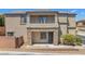 Home with a gated front entry, a covered front porch, and desert landscaping at 7865 Solid Horn Ct, Las Vegas, NV 89149
