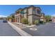 Two-story home with stone accents, a two-car garage, and manicured landscaping, set on a corner lot at 7865 Solid Horn Ct, Las Vegas, NV 89149