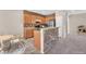Modern kitchen with stainless steel appliances, wood cabinetry, stone accent wall, and breakfast bar seating at 7865 Solid Horn Ct, Las Vegas, NV 89149