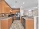 Well-equipped kitchen with stainless steel appliances, wood cabinets, tile backsplash, and an open layout at 7865 Solid Horn Ct, Las Vegas, NV 89149