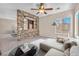 Stylish living room with a unique stone wall, neutral decor, and a cozy seating area for relaxing or entertaining at 7865 Solid Horn Ct, Las Vegas, NV 89149