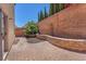 Private outdoor patio featuring pavers, mature trees, landscaping, and a low retaining wall at 7865 Solid Horn Ct, Las Vegas, NV 89149