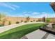 Well-maintained backyard with manicured artificial grass, planters along the block wall, and desert landscaping at 8902 Sasquatch Run Ave, Las Vegas, NV 89166