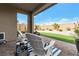 Cozy covered patio featuring comfortable seating, brick pavers, and a view of the landscaped backyard at 8902 Sasquatch Run Ave, Las Vegas, NV 89166