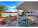 Charming covered patio area perfect for outdoor dining and entertaining in a landscaped backyard at 9021 Canyon Magic Ave, Las Vegas, NV 89129