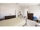 Bright bedroom with a wrought iron bed frame, neutral walls and carpet, and a double-door closet at 9021 Canyon Magic Ave, Las Vegas, NV 89129