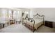 Bright bedroom featuring a wrought iron bed, comfortable seating, and abundant natural light for a cozy retreat at 9021 Canyon Magic Ave, Las Vegas, NV 89129