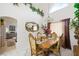 Charming dining area featuring classic wooden table set beneath a high, arched window at 9021 Canyon Magic Ave, Las Vegas, NV 89129