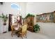 Cozy dining area featuring a classic wooden table set beneath a high, arched window at 9021 Canyon Magic Ave, Las Vegas, NV 89129