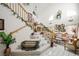 Elegant entryway with a grand staircase, decorative plants, and stylish decor, setting a sophisticated tone at 9021 Canyon Magic Ave, Las Vegas, NV 89129