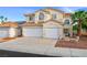 Inviting two-story home with attached two-car garage and a charming desert landscape at 9021 Canyon Magic Ave, Las Vegas, NV 89129