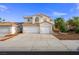 Inviting two-story home with attached two-car garage and a charming desert landscape at 9021 Canyon Magic Ave, Las Vegas, NV 89129