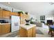 Open kitchen, breakfast nook, and living room concept with oak cabinets at 9021 Canyon Magic Ave, Las Vegas, NV 89129