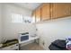 Compact laundry room featuring built-in storage and a small window for natural light at 9021 Canyon Magic Ave, Las Vegas, NV 89129