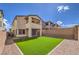 Home backyard with artificial turf, rock landscaping, and a block wall under a clear blue sky at 11640 Desert Hollow Ave, Las Vegas, NV 89138
