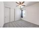 Comfortable bedroom with a ceiling fan, carpet, and double door closet at 11640 Desert Hollow Ave, Las Vegas, NV 89138