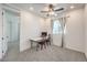 Neutral bedroom features a ceiling fan and bright natural light from the window at 11640 Desert Hollow Ave, Las Vegas, NV 89138