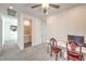 Cozy bedroom features a ceiling fan and a simple desk with two chairs at 11640 Desert Hollow Ave, Las Vegas, NV 89138