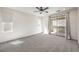 Bedroom featuring neutral carpet, large windows, and access to a private balcony at 11640 Desert Hollow Ave, Las Vegas, NV 89138