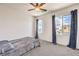 Inviting bedroom featuring carpet, ceiling fan, and natural light from the windows at 11640 Desert Hollow Ave, Las Vegas, NV 89138