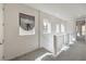 Second floor hallway with neutral carpet and modern railing at 11640 Desert Hollow Ave, Las Vegas, NV 89138