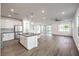 Spacious kitchen with island seating overlooking the living area and backyard access via sliding glass doors at 11640 Desert Hollow Ave, Las Vegas, NV 89138